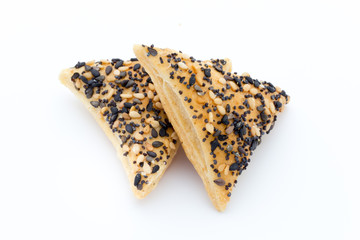 Crisps with nuts and seeds stacked on a white background.