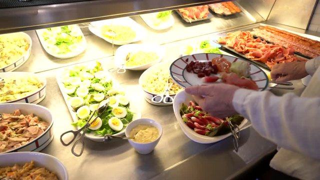 People serving themselves in restaurant buffet
