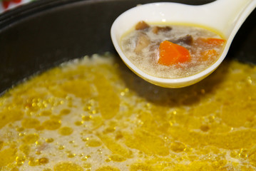 Appetizing soup with mushrooms cooked in slow cooker