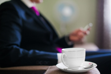 Cup of Coffee on a Saucer with Tea Spoon Focused