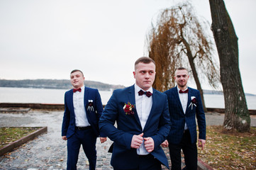 Groom with best mans at cold winter wedding day.