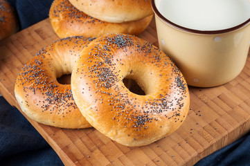 Fresh homemade Poppy bagels bread with cup of milk