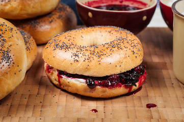 Fresh homemade Poppy bagels bread with cup of milk, cream cheese