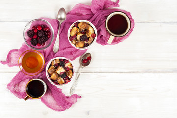 Obraz na płótnie Canvas French toast casserole with cranberries, raspberries and blackbe