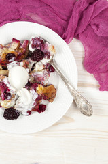 French toast casserole with berries and vanilla ice cream on whi