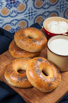 Fresh homemade Poppy bagels bread with cup of milk