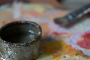 Oil painting palette with cup of turpentine