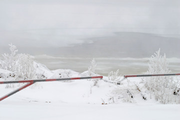 Barrier near the river in winter