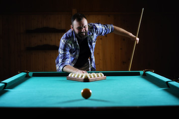 Fototapeta premium hansome man playing billiards alone