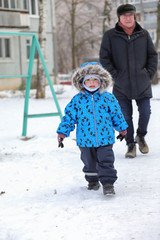 kids playing with snow in winter on backyard