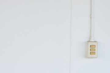 Old light switch on a white wall