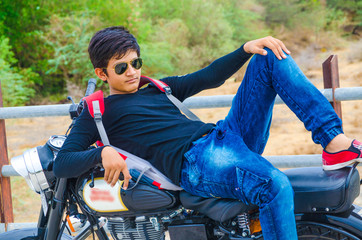 Asian Male Student Is A Sitting On The Motorbike