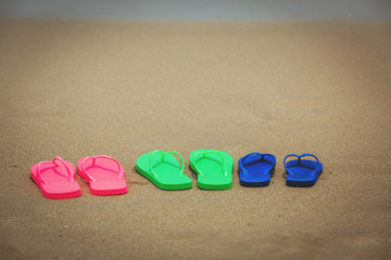 Fototapeta na wymiar family beach flip flops at sea