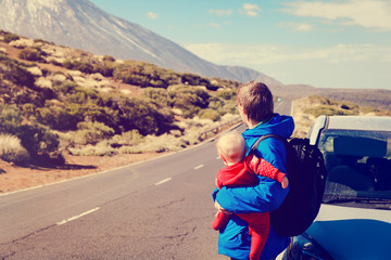 family travel by car-father with baby on road in mountains