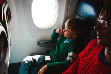 Fototapeta na wymiar father and little son travel by plane