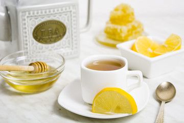 A cup of tea with lemon and honey for health