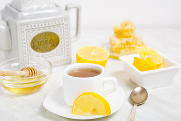 A cup of tea with lemon and honey for health