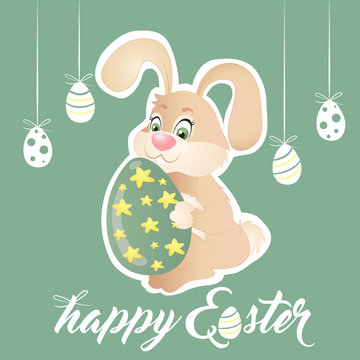Easter bunny holding green egg with stars