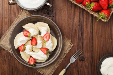 Delicious dumplings with fresh strawberries served with whipped