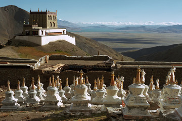 View to the Buddhist monastery Gyantak gompa and ritual structures Stupas on the hillside of sacred...
