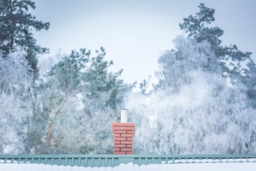 House chimney on roof in winter
