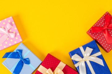 Many color gift box on yellow color background.