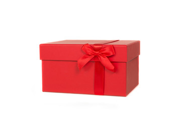 Single red gift box with a red ribbon isolated on a white background