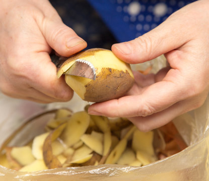 chef peeling potatoes
