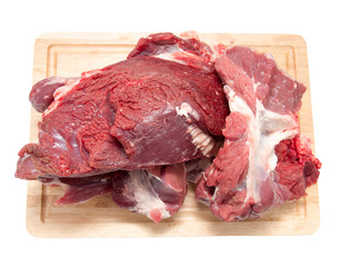 meat on a board on a white background