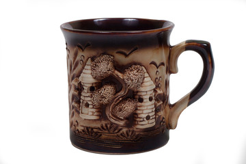brown mug with moldings in the form of two towers and a tree