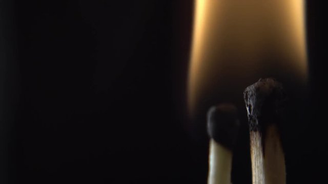 burning matches close-up on black background