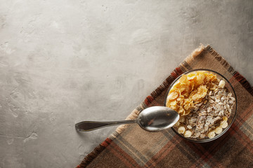 Fresh muesli in a glass plate on the table with a napkin