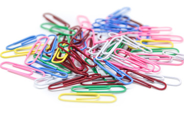 multi-colored paper clips on white background