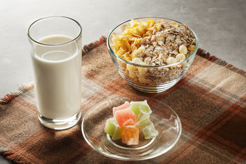 Fresh muesli in a glass plate on the table with a napkin