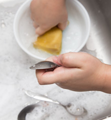 boy washing dishes in the kitchen