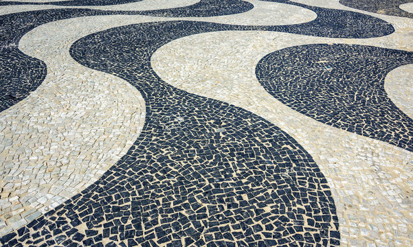 Black and white iconic mosaic, Portuguese pavement by old design pattern at Copacabana Beach, Rio de Janeiro, Brazil