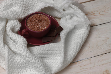 Milk chocolate in a cup on a saucer against a background of a sc