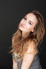 Fototapeta premium Young beautiful woman posing over dark background