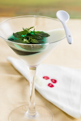 panna cotta with mint syrup and fresh leaves