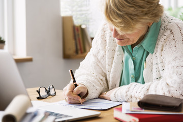 Senior Woman Filling Application Form Documents Concept