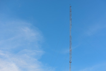 Phone antenna with blue sky background.