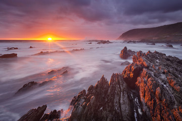 Sunset over the ocean in Garden Route NP, South Africa