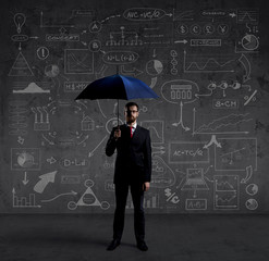 Businessman with umbrella. Black background with copyspace. Busi