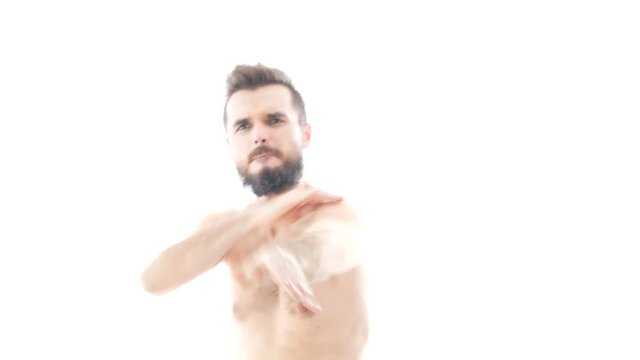 Vigorous self-confident bearded naked man dancing on trap hip-hop music, studio isolated on white background.