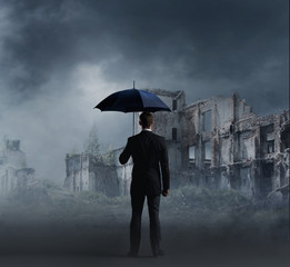 Businessman with umbrella. Black background with copyspace. Busi