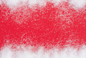 White Snow On Red Paper Background Top View.