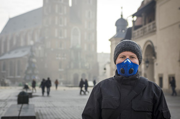 Man using a mask,  protecting himself from smog - obrazy, fototapety, plakaty