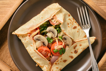 Pancakes sutffed with ham, cheese, tomatoes and mushrooms.