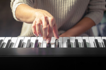 Closeup of hands playing piano. Music and hobby concept