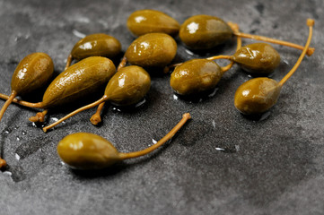 Green capers on a rustic background